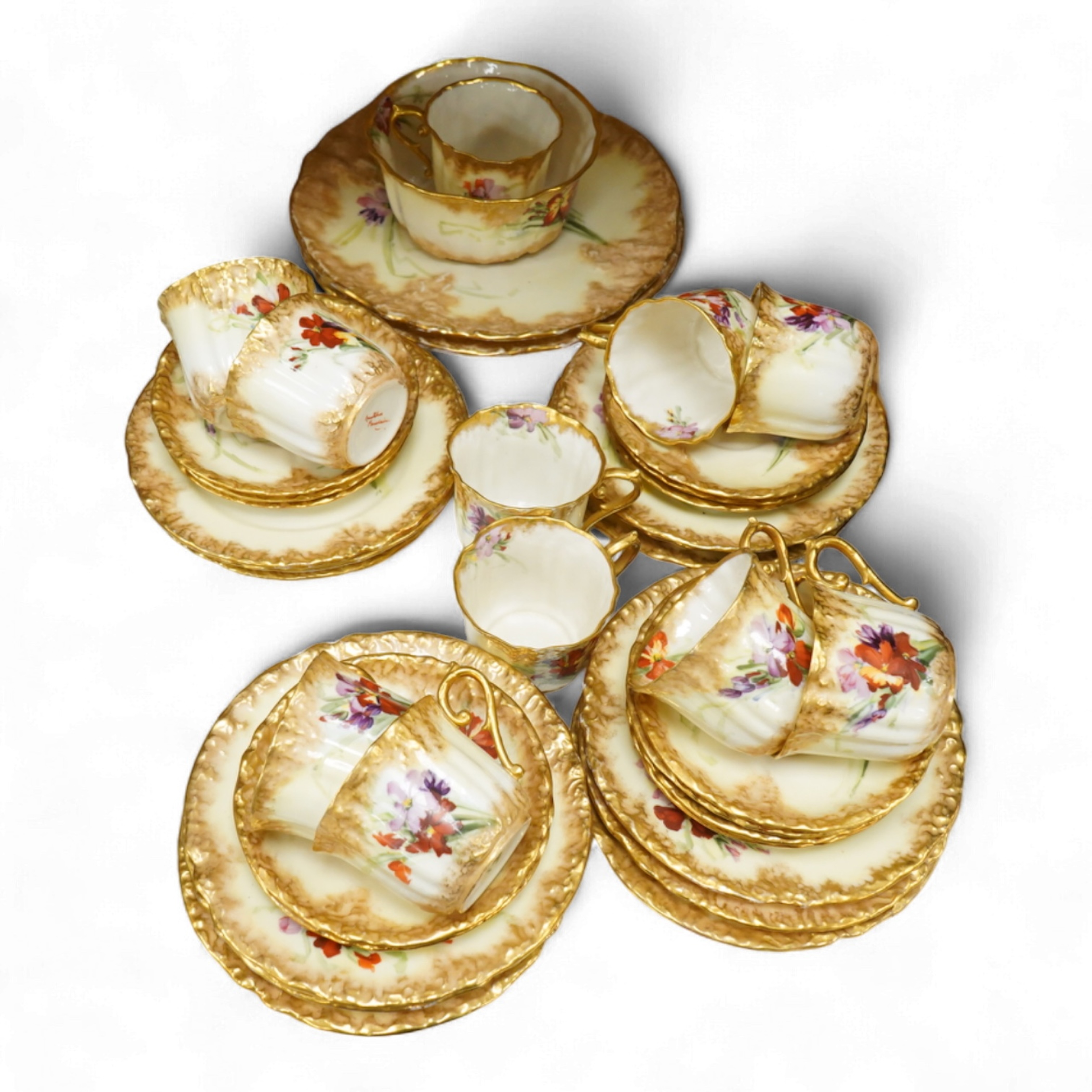 A ‘Nautilus’ porcelain floral and gilt decorated tea service, sandwich plates 23cm diameter.